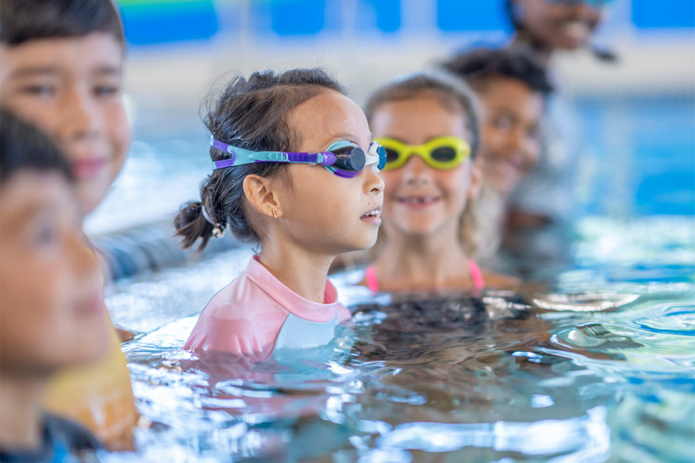 group of children standing together in swimming pool